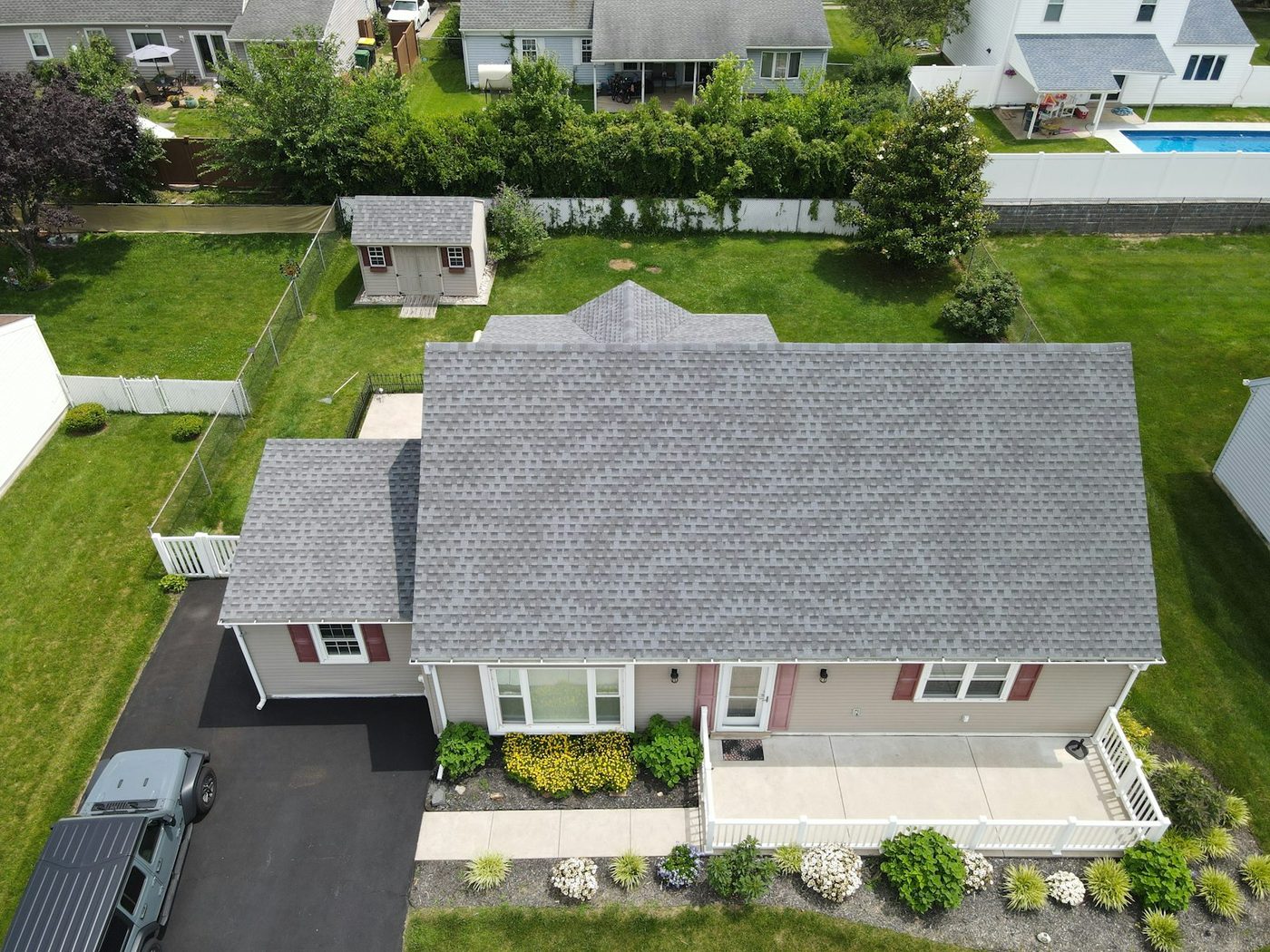 Aerial view of a residential asphalt-shingle roof after installation