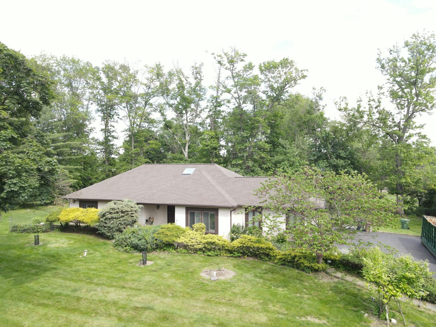 Ranch-style home with a brown asphalt-shingle hip roof