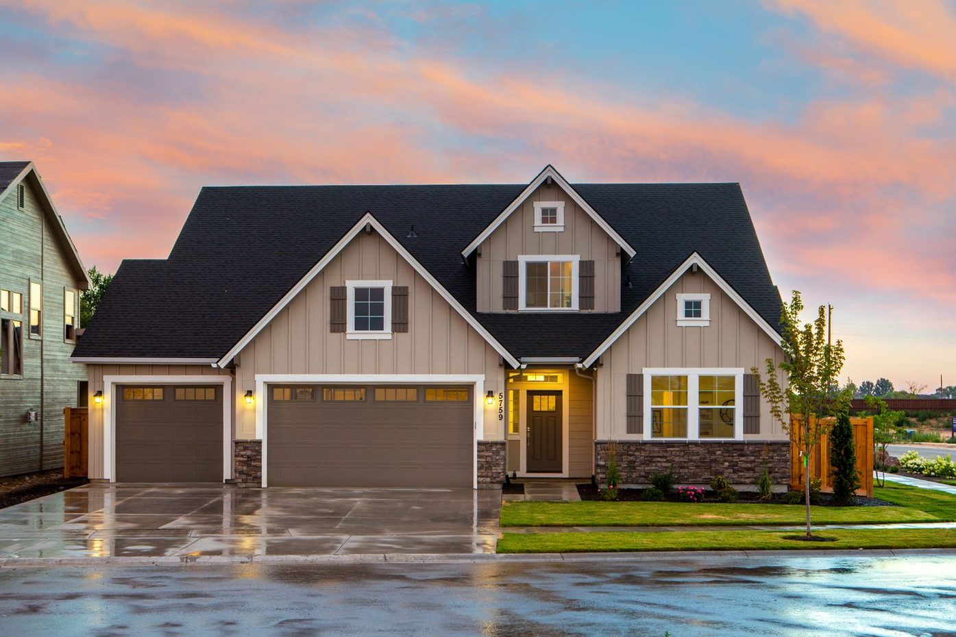 Two-story home with a dark Onyx-style shingle roof at dusk