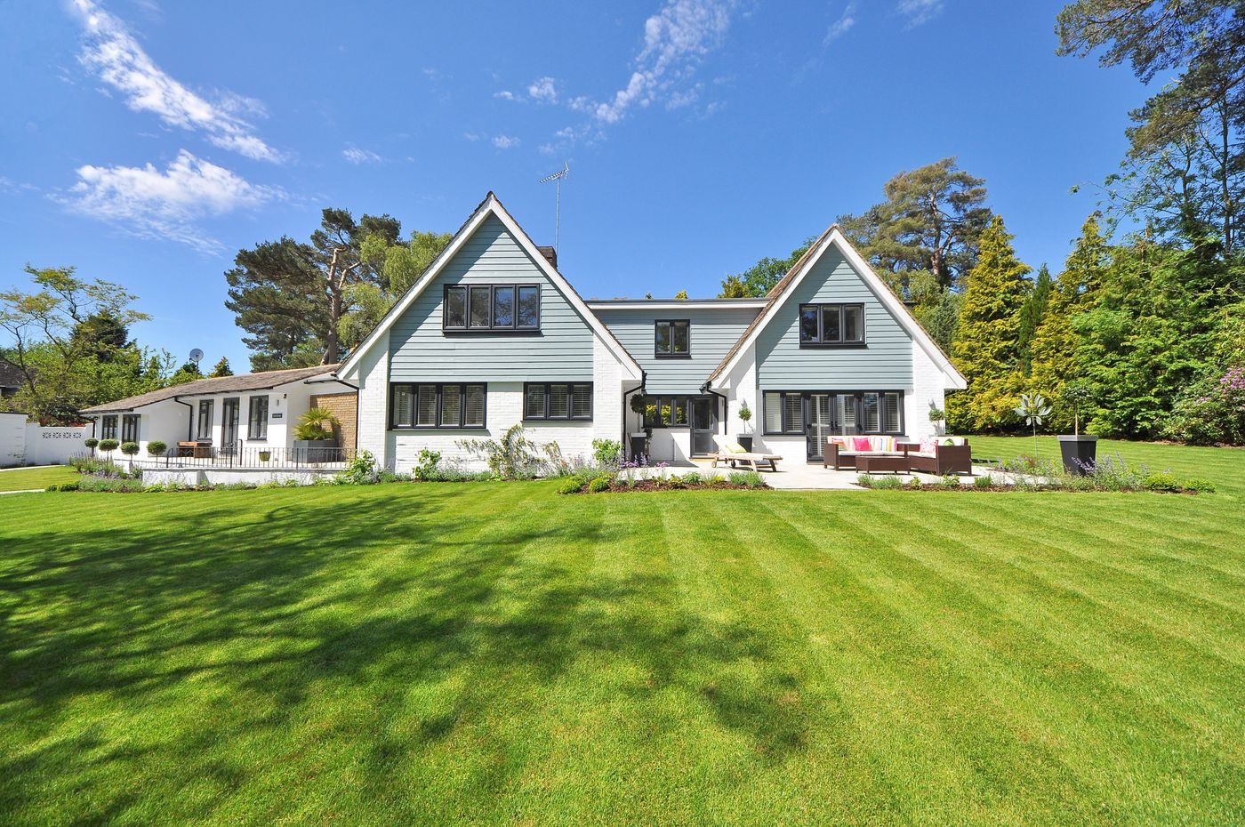 Modern farmhouse with a multi-gable charcoal shingle roof